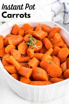 a white bowl filled with carrots on top of a table