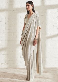 The champagne is the bestselling color in the metallic range. Our signature metallic 2.0 sari now comes with a built in petticoat. Lightweight, fuss free and easy to wear, it’s the perfect piece to carry to destination weddings. Reach out to shop the blouse separately. Silver Pre-draped Saree For Wedding, Nehru Jackets, Western Wedding, Wedding Service, Short Suit, Bride Bridal, Petticoat, Designer Earrings, Gowns Dresses