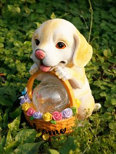 a yellow lab puppy sitting in the grass with a basket and flowers around it's neck