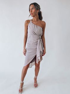 DETAILS: Our Aryanna Ruched Midi Dress is lined with a silk lining. This dress has a one shoulder detail with an adjustable self tie back. The back of the dress has a zipper closure with a hook and eye clasp. The front of the dress has ruching detail, a side slit with a sash detail over it. The bust area does run big. CONTENT & CARE: SELF: 100% Polyester. LINING: 100% Polyester. SIZE & FIT: Model is 5'6" The model is wearing a size small. Fits true to size The Fabric has some stretch Ruched Midi Dress, A Hook, Over It, Tie Backs, Tie Back, One Shoulder Formal Dress, One Shoulder Dress, Wrap Dress, The Dress