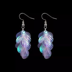 Dive into these dazzling Iridescent Mermaid Tail Earrings! They feature a hook design for all day comfort and a multicolored sheen that shifts in the light - from pink to purple to green to blue. Enjoy the ultimate sparkle without the weight! Earrings base color is pink but changes color based on light angle and background color. Fun color changing earrings. Adjustable Iridescent Drop Earrings, Iridescent Party Earrings, Party Jewelry With Iridescent Ear Wire, Iridescent Dangle Earrings Nickel Free, Iridescent Nickel-free Dangle Earrings, Iridescent Dangle Crystal Earrings For Pierced Ears, Iridescent Hypoallergenic Earrings For Party, Iridescent Drop Earrings For Pierced Ears, Hypoallergenic Iridescent Earrings For Parties