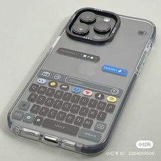 an iphone case with a keyboard on the back and buttons attached to it, sitting on top of a table