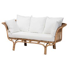 a wicker couch with white pillows on it's back and side cushions in the front