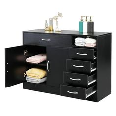 a bathroom vanity with drawers and towels on it's sideboard, in black finish