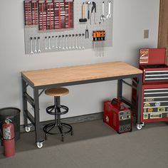 a workbench with tools hanging on the wall