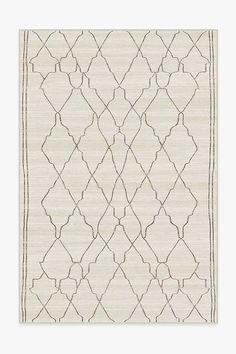 a white rug with an intricate design on the bottom and sides, in grey tones