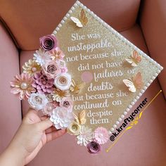 someone is holding a graduation cap with flowers on it that says she was unstopable not because she did not have daughters, but because she won't