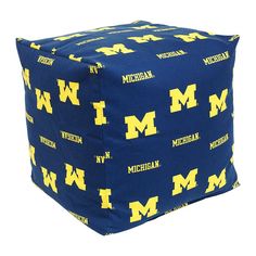 a blue and yellow michigan university ottoman cover