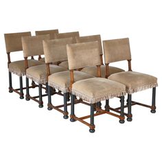 six chairs with fringed seats are lined up