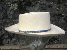 A chic RESISTOL Shantung Panama straw hat in the "Gambler Style."  Made in U.S.A.  The hat is accented with a colorful band embellished with small, decorative, silver conchos.  It has a ~3" brim and a 6 ½" long oval crown.  Style Name: Fandango  Color: Natural This hat is in quality condition with little evidence of use.  Clean.  No rips, tears, holes or creases.  Ideal for the golf course, barbecue, garden, etc.  Combined shipping available for multiple items.  In the event that there is a ques Country Style Fitted Straw Hat With Flat Bill, Fitted Country Style Sun Hat With Flat Bill, Fandango Color, Barbecue Garden, The Gambler, Straw Hat, Golf Course, Fedora, Panama