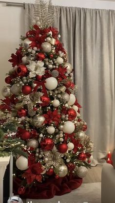 a christmas tree decorated with red and silver ornaments