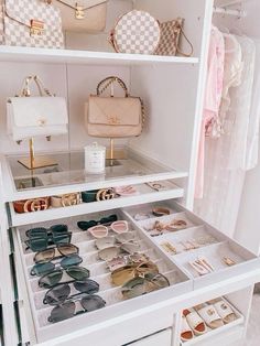 a white closet filled with lots of purses and handbags on top of shelves