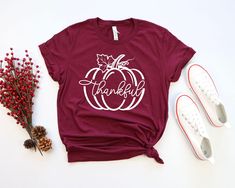 Thankful, Thankful Pumpkin, Thanksgiving shirt, Thankful Tee, Pumpkin Shirt, Fall Shirt, Unisex tee,Thanksgiving Family Matching Shirt ABOUT US: Are you looking for customized soft/lovely/comfy apparels for your loved ones? Then welcome to TXcustomtee Customer service is always our priority. If you have any questions, please feel free to message. HOW TO ORDER: * Select your clothing style, size and color from drop down menus. * Select the quantity. * (If provided for that listing) Add your infor Red Graphic Tee For Fall, Fall Season T-shirt Gift, Fall Gift T-shirt With Short Sleeves, Short Sleeve T-shirt For Fall Gift, Fall Short Sleeve Tops For Gifts, Fall Short Sleeve Tops For Gift, Short Sleeve Tops For Fall Gift, Letter Print T-shirt As Fall Gift, White T-shirt For Fall Season Gift