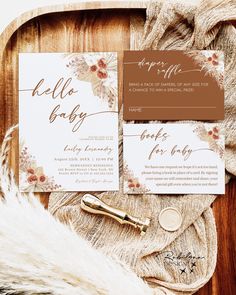 the wedding stationery is laid out on a wooden tray with fur and gold accents