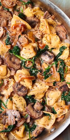 pasta with mushrooms and spinach in a pan