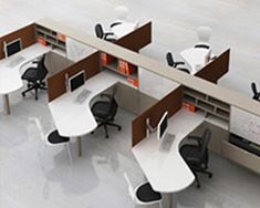 an office cubicle with multiple desks and chairs