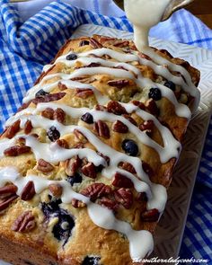 a loaf of blueberry bread drizzled with icing