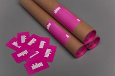 some pink stickers are on top of a roll of brown paper