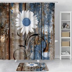 a large white flower sitting on top of a wooden floor next to a shower curtain