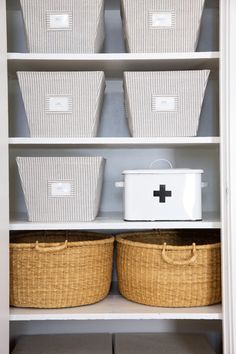 some baskets are sitting on top of the shelves