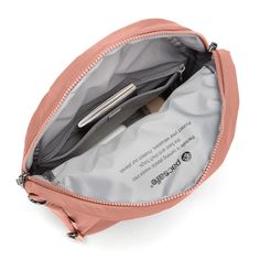 the inside of a pink purse with an open zippered pocket on one side and a pen sticking out of it