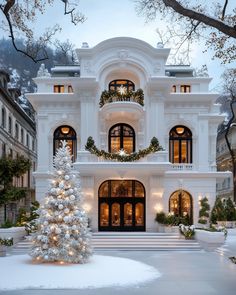 a large white house with a christmas tree in front