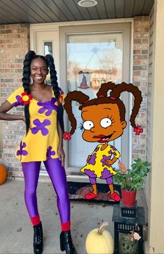 a woman standing in front of a cartoon character