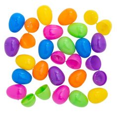 many different colored plastic eggs on a white background