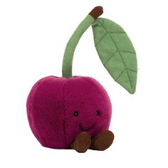 an apple stuffed animal with a leaf on it's head and eyes, sitting against a white background