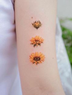 three sunflowers on the left arm and one is yellow with green leaves in it