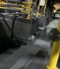 the interior of a public transit bus with seats and railings on both sides,