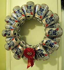 a wreath made out of cans with a red ribbon around the top and number 40 on it