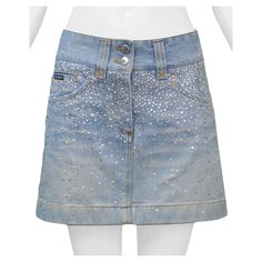 Resurrection Vintage is excited to offer a vintage Dolce & Gabbana denim mini skirt featuring yellow stitching, back patch pockets, and a rhinestone and pearl gradient on the front and back of the skirt. Dolce & Gabbana Size 38 Cotton Excellent Vintage Condition Authenticity Guaranteed Rhinestone Denim Skirt, Hslot Outfit, Back Patch, Denim Mini, Clothing Ideas, Crystal Pearls, Dolce & Gabbana, Denim Mini Skirt, Jean Skirt