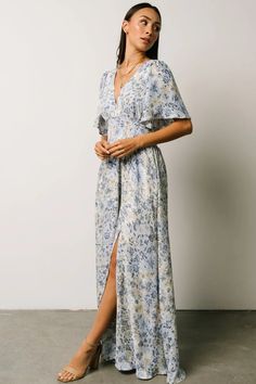 This lovely Verona Smocked Maxi in blue floral is absolutely gorgeous! It is perfect for any occasion! Flowy V-neck Maxi Dress With Elastic Sleeves, Flowy Chiffon Short Sleeve Dress For Vacation, Flowy Chiffon Dress With Short Sleeves For Vacation, Casual Summer Maxi Dress With Elastic Sleeves, Summer Beach Maxi Dress With Elastic Sleeves, Chic Flowy Maxi Dress With Butterfly Sleeves, Chic Chiffon Maxi Dress With Smocked Bodice, Billowy Chiffon Maxi Dress For Spring, V-neck Chiffon Dress With Smocked Bodice