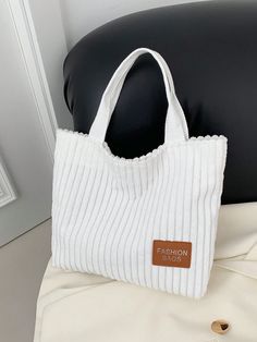 Add a touch of sophistication and functionality to your wardrobe with our Style Corduroy Tote Bag. Combining chic design with spacious interior, this bag is perfect for all your daily essentials. Its casual style makes it versatile for any occasion. Elevate your fashion game with this must-have accessory. Color : White Strap Type : Double Handle Style : Preppy Bag Size : Small Type : Shoulder Tote Bag Pattern Type : Plain Closure Type : Magnet Magnetic : Yes Material : Canvas Composition : 100% Linen Bag Height Bag Length Bag Width 23 32 7 Trendy Solid Color Canvas Bag, White Cotton Bag With Zipper Closure, Trendy Cotton Bag With Double Handles, Trendy Double Handle Cotton Bag, Trendy Cotton Double Handle Bags, Spring Cotton Bags For Errands, Trendy White Canvas Bag With Zipper Closure, Trendy White Canvas Bag With Zipper, White Fabric Shoulder Bag For Shopping