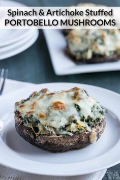 baked stuffed mushrooms with cheese and spinach on a white plate next to another one