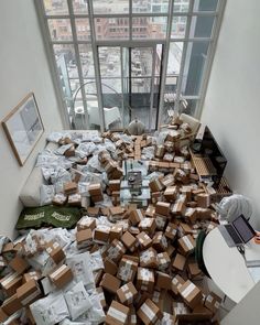 a pile of boxes sitting on top of a floor in front of a large window