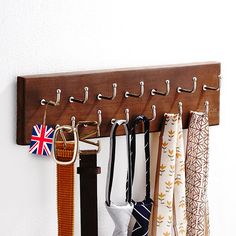 a coat rack with several ties hanging from it's hooks and an union jack flag pin