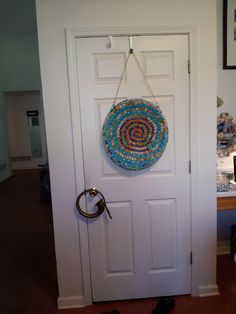 a white door with a colorful rug hanging on it