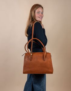 Kate Cognac Stromboli Leather Crossbody Shoulder Bag with Large Straps by O My Bag. Model image Elegant Cognac Satchel For Office, Modern Cognac Satchel For Office, Elegant Travel Satchel In Cognac, Elegant Cognac Briefcase With Detachable Strap, Elegant Cognac Satchel For Travel, Chic Cognac Satchel For Business, Elegant Everyday Cognac Satchel, Versatile Brown Formal Satchel, Versatile Cognac Shoulder Bag For Business