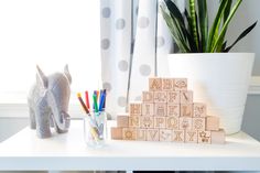 a white table topped with wooden blocks and markers