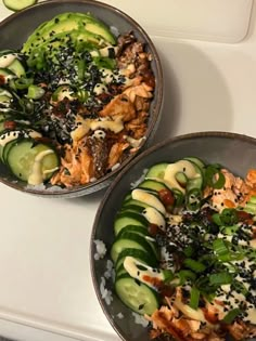 two bowls filled with food sitting on top of a white counter next to each other