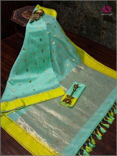 Chanderi saree in teal green with neon green border is a stunning combination. Teal green is a rich, elegant color that complements various skin tones, and the golden buttas spread across the body add a touch of traditional opulence. The neon green border provides a striking contrast, infusing a modern and vibrant feel into the classic Chanderi weave. Overall, this saree is a unique blend of classic craftsmanship and contemporary aesthetics, perfect for special occasions or cultural events. Fall and Pico - Done. Blouse - Unstitched. Custom fancy tassels. Please note: Color may vary slightly from the picture. Thread knots, thread pulls and minor inconsistencies are characteristic in Natural fiber sarees like cotton and it is not a defect. Festive Green Designer Saree, Designer Green Cotton Silk Saree, Designer Green Saree With Zari Weaving, Green Chanderi Saree With Zari Work, Designer Green Saree With Traditional Drape, Designer Green Saree In Traditional Drape, Green Tussar Silk Saree For Designer Wear, Festive Green Cotton Silk Saree, Green Cotton Silk Saree With Zari Weaving