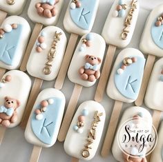 there are many decorated cookies on sticks with the letters k and teddy bears in them