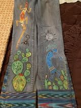 a pair of jeans with pictures painted on them