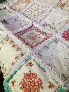 an old quilt that has been made into a baby blanket with ruffles and flowers on it