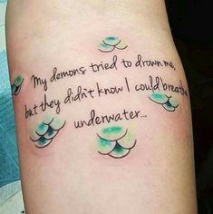 a woman with a tattoo on her leg that reads, my demons tried to drown me, but they didn't know i could be underwater