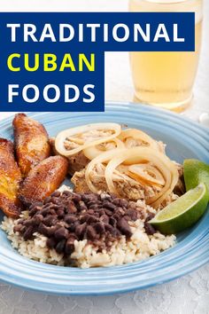 a blue plate topped with rice and beans next to a glass of beer on top of a table