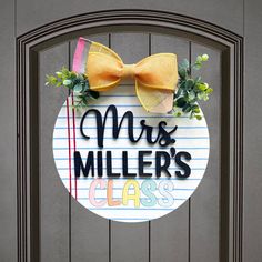 a door with a sign that says mrs miller's class and a bow on it