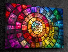 a multicolored stained glass window on the wall